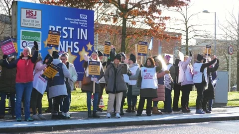 NHS nurses strike for fair pay and better care outside St Helens hospital Stock Footage 231341504