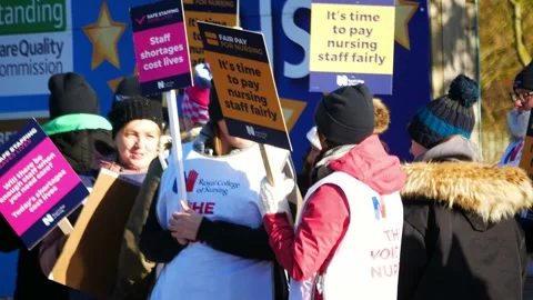 NHS nurses strike in unity for fair pay and better care outside St Helens Stock Footage 231341407
