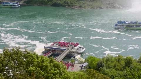 Niagara Falls, Canada - September 03, 2026: Tourists board a red-poncho tour Stock Footage 345678765