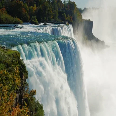 Niagara Falls in the sun. A huge cloud of spray and mist Stock Footage 69408806