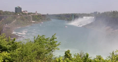 Niagara River gorge with red and blue tour boats near American Falls Video stock 320026499