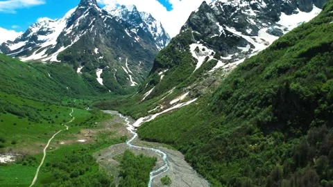 Nice aerial view of the mountain valley and high mountain slopes. Stock Footage 157236934