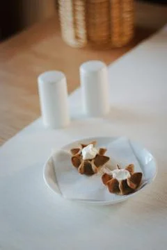 Nice appetizer snacks - tartlets on a white ceramic plate. Stock Photos