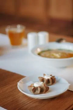 Nice appetizer snacks - tartlets on a white ceramic plate. Stock Photos