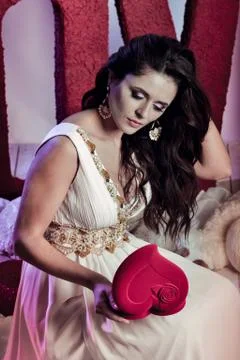 Nice, attractive, beautiful girl, model inclined the head, holds heart in hands Stock Photos