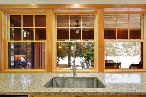 Nice backyard view from the window of luxurious kitchen. Stock Photos