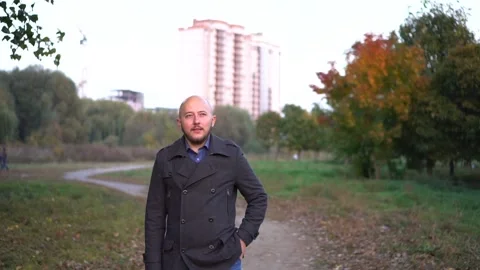 Nice bald-headed man read messege on cellphone and smiling. Camera stabilizer Stock Footage 97116705
