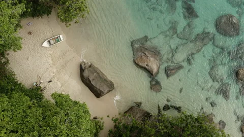 Nice beach. The men pull one of the boats off the beach. Top view 90 degrees 스톡 동영상 140475525