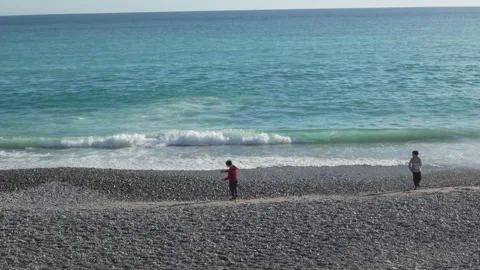 Nice Beach - People Walking Along Shoreline. Video stock 329583063
