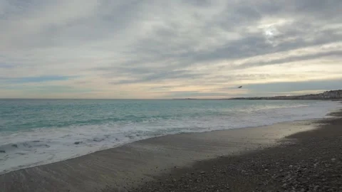 Nice Beach Waves and Cityline Under Cloudy Sky Stock Footage 329585940