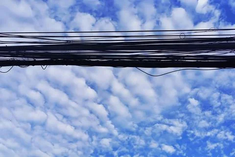Nice Blue Sky White Cloud With Messy and Confused Electric Wire Cable Stock Photos