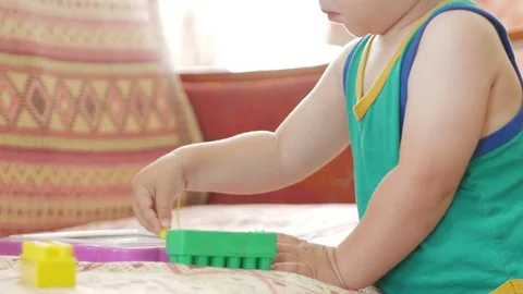 A nice boy of 2 years draws on a magnetic drawing board. He has great Stock Footage 78619175