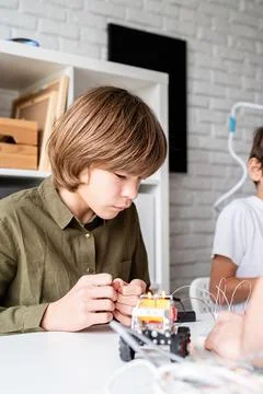 Nice boy constructing a robot car Stock Photos