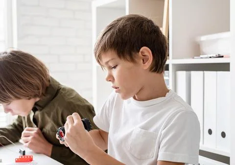 Nice boy constructing a robot car Stock Photos