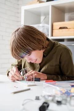 Nice boy constructing a robot car playing with lights Stock Photos
