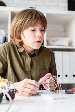 Nice boy constructing a robot car Stock Photos