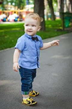 Nice boy walking in the park in summer Stock Photos