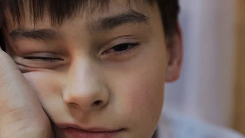 Nice brown-haired Caucasian guy falling asleep during bored lesson in school Stock Footage 98602254