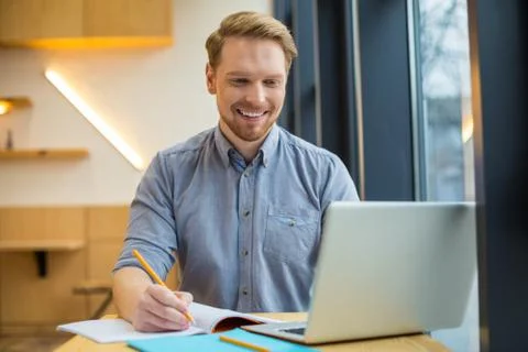 Nice cheerful man working Stockfoto's
