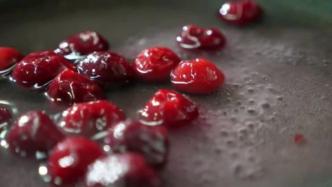 Nice cherries mixed with sugar boiling on a frying pan in a restaurant kitchen Stock-Footage 135231181