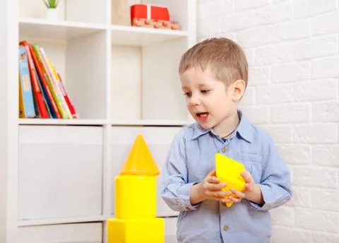 Nice child playing with constructor on floor at home Foto stock