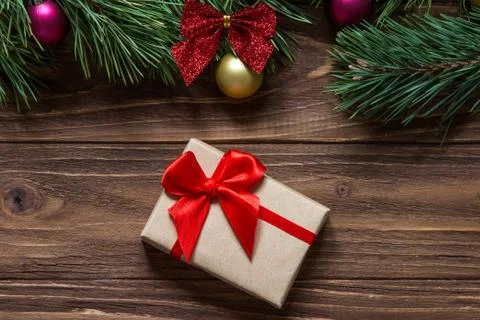 Nice Christmas gift box macro on the wooden background with pine tree branches Stock Photos