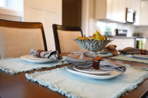 Nice close up of a dining table with dinner setting: beautifully folded napki Stock Photos