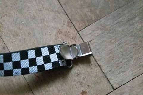 Nice close up of lock plaid braces on a wood background Stock Photos
