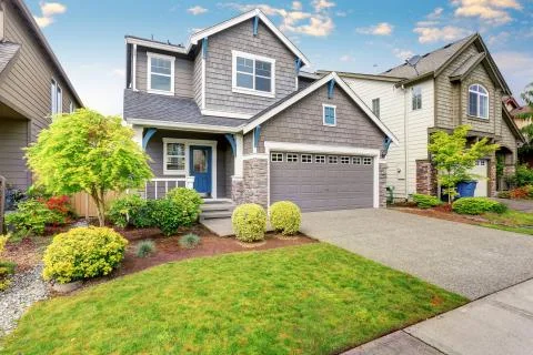 Nice curb appeal of two level house, mocha exterior paint and driveway Stock Photos