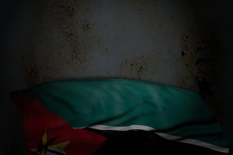 Nice dark image of Mozambique flag with large folds on rusty metal with empty Illustrazione stock