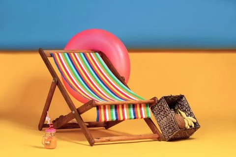 Nice deck chair at improvised artificial beach, complete with in Stock Photos
