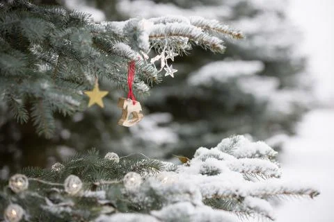 Nice decorations on a Christmas tree with snow outdoors. Celebration, winter  Stock Photos