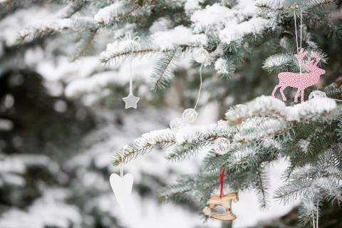Nice decorations on a Christmas tree with snow outdoors. Celebration, winter  Stock Photos