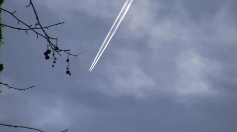 Nice distant realtime jet flyby diagonal w-trail vortex Stock Footage 47674979