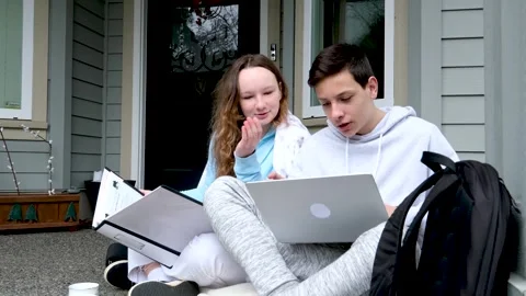 Nice to do homework together with a friend boys girl sitting on the porch laptop Vídeos de archivo 243234460