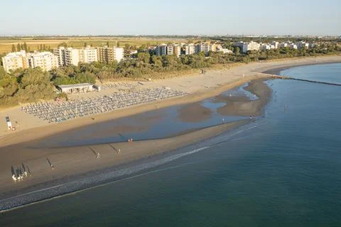 Nice Drone view of sandy beach with umbrellas and gazebos Photos