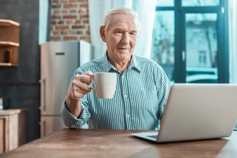Nice elderly man having tea Stock Photos