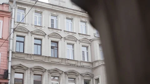 Nice facade of old beige building with several windows and rain gutter pipe Stock Footage 107111683