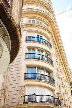 Nice facade of old design building in the main avenue of the city Stock Photos