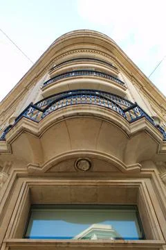Nice facade of old design building in the main avenue of the city Stock Photos