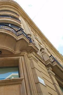 Nice facade of old design building in the main avenue of the city Stock Photos