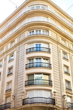 Nice facade of old design building in the main avenue of the city Stock Photos
