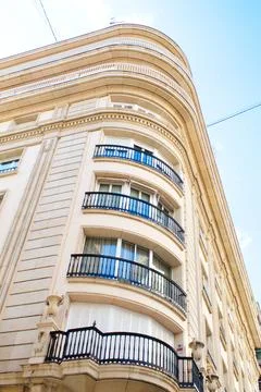 Nice facade of old design building in the main avenue of the city Stock Photos
