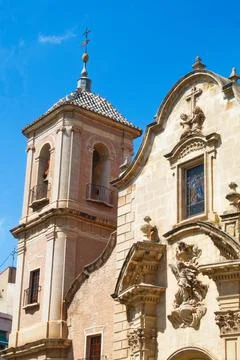 Nice facade with tower and bell tower of the church of Santa Eulalia in Murcia Stock Photos