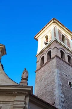Nice facade with tower and bell tower of the church of Saint Peter in Murcia Stock Photos