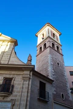 Nice facade with tower and bell tower of the church of Saint Peter in Murcia Stock Photos