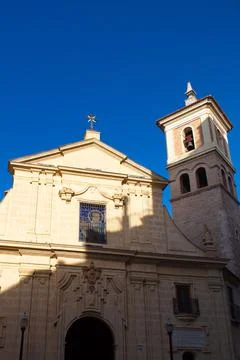 Nice facade with tower and bell tower of the church of Saint Peter in Murcia Stock Photos