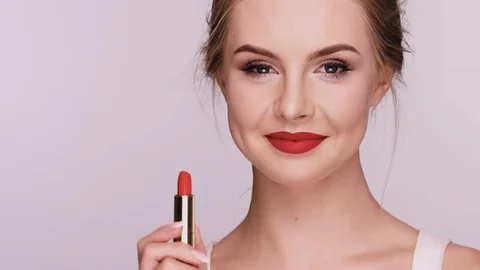 Nice female doing make-up and showing heart with lipstick Stock Footage 110201908