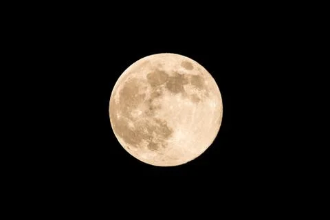 Nice full moon with soft yellow color an visible craters Stock Photos