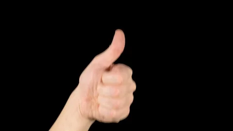 Nice gesture. A man's hand on a black background shows like. Stock Footage 119997247